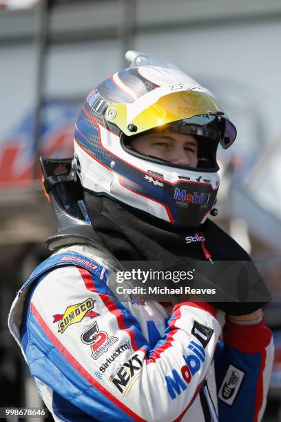 Todd Gilliland, driver of the Mobil 1 Toyota, stands in the garage area prior to practice for the NASCAR Camping World Truck Series Buckle Up in Your...