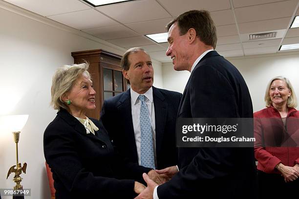 Jill Cooper Udall's wife, Tom Udall, D-NM., greet Mark Warner, D-VA., during their first day in the U.S. Senate on January 6, 2009.