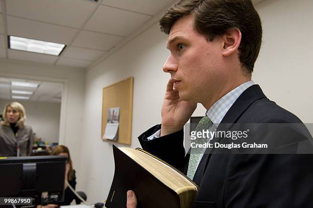 Personal Assistant Andrew Smith holds the bible that will be used to swear in freshmen Mark Warner, D-VA., during their first day in the U.S. Senate...