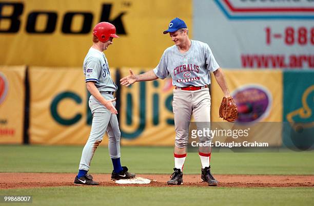 Adam Putnam gets a hand shake from Brian Baird after he stole 2nd during the 2003 congressional baseball game.