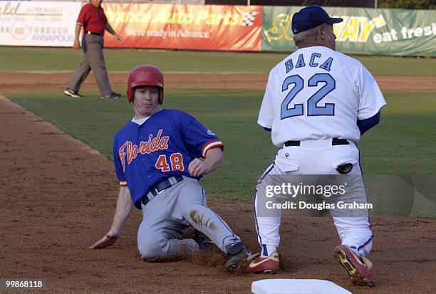 Adam Putnam slides safe into 3rd base safe after Joe Baca droped the ball during the 2004 Congressional Baseball Game.