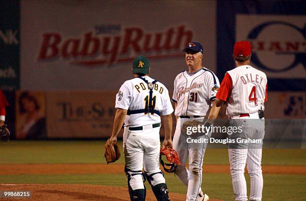 Richard Pombo, John Shimkus and coach Mike Oxley have a little meeting of the minds after the Democrat's rallied in the last inning during the 2003...