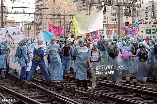 French anaesthetist nurses stand on tracks near the Montparnasse train station on May 18, 2010 in Paris, during a demonstration blocking the speed...