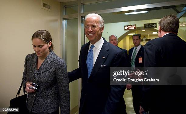 Vice President elect Joe Biden, D-DE., gets a pat on the back by Mark Warner, R-VA., after being sworn in by standing VP Richard Cheney during his...