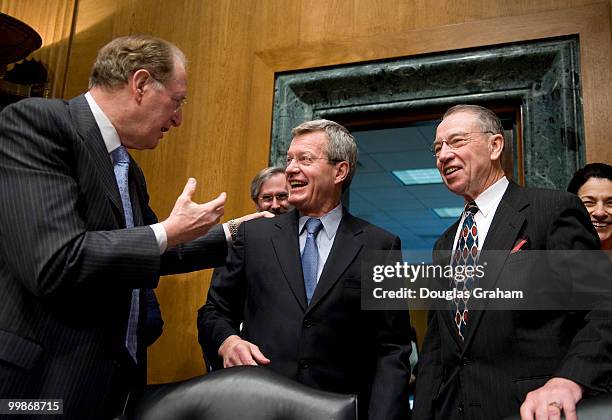 John D. Rockefeller, D-WV., greets a surprised Senator Max Baucus, D-MT., while Chuck Grassley, R-IA., looks on during a short ceremony at the start...