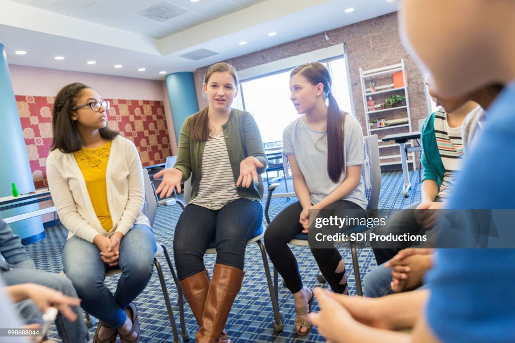 Teenage girl talks during support group meeting