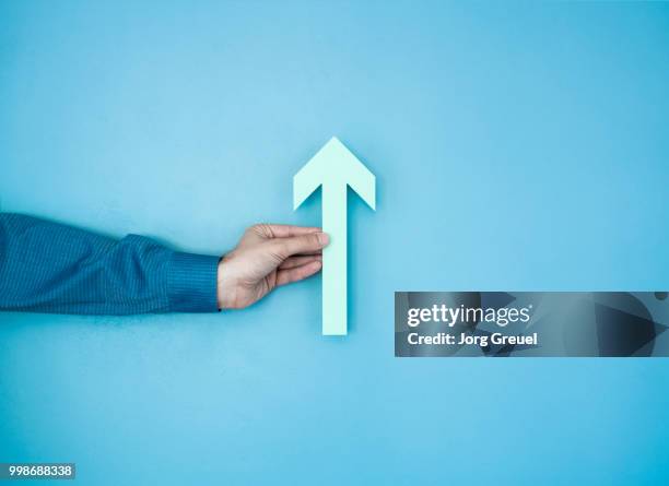 hand holding paper arrow - growing signs of resictence and protest are found in liberal neighborhood in northwest philadelpha pa stockfoto's en -beelden