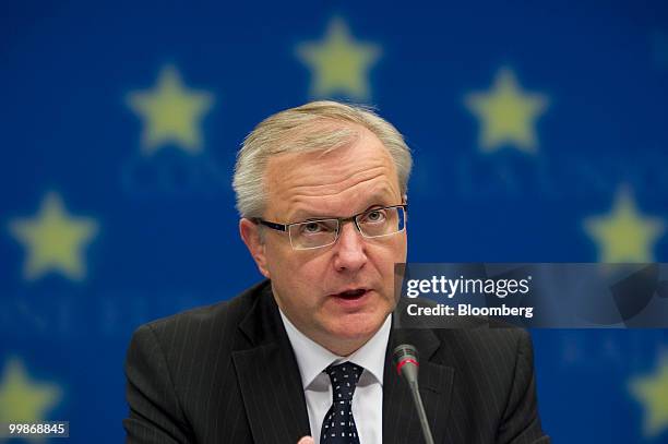 Olli Rehn, the European Union's economic and monetary affairs commissioner, speaks during a news conference following the meeting of European Union...