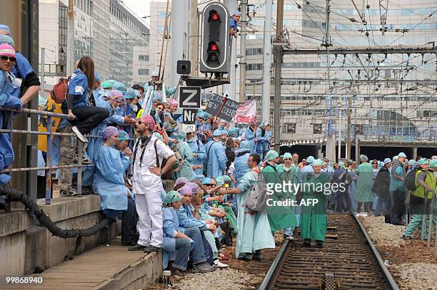 French anaesthetist nurses stand on tracks near the Montparnasse train station on May 18, 2010 in Paris, during a demonstration blocking the speed...