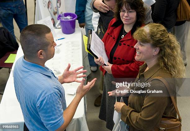 Edward Rodriguez of Culpeper Regional Hospital talks with Susan Patsel of Culpeper during the job fair at the Germanna Community College, Daniel...