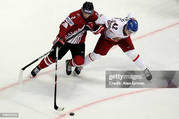 Kris Russell of Canada is challenged by Petr Koukal of Czech Republic during the IIHF World Championship group F qualification round match between...