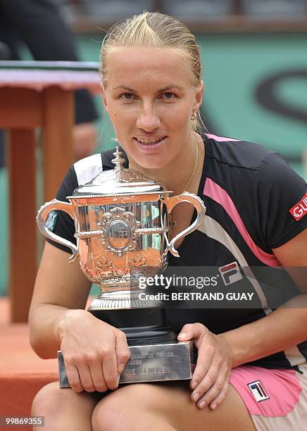 Russia's Svetlana Kuznetsova poses with the winners trophy after beating Russia's Dinara Safina during a French Open tennis final match on June 6,...