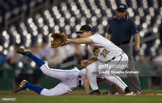 Anthony Weiner, D-NY., dives back too first as Kenny Hulshof, R-MO., waits for the ball during the 47th Annual Roll Call Congressional Baseball Game...