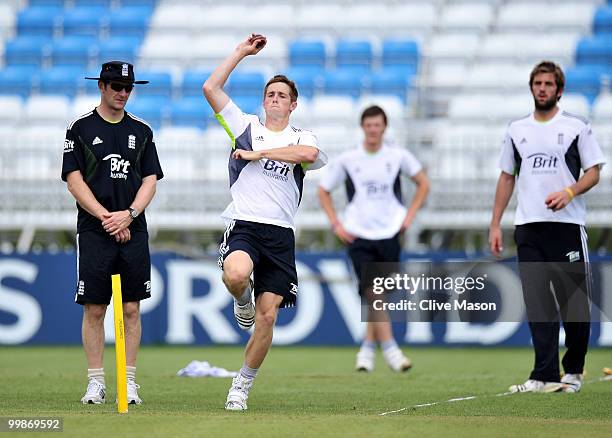 Chris Woakes of England Lions bowls as bowling coach Kevin Shine looks on during a net session at The County Ground on May 18, 2010 in Derby, England.