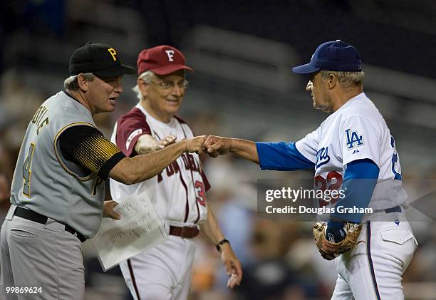 Mike Doyle, D-PA., and Bill Pascrell, D-NJ, give Joe Baca, D-Ca, a fist-bump for a job well done on the mound during the 48th Annual Roll Call...