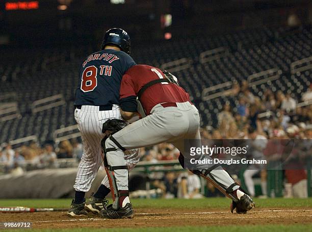 Christopher Murphy, D-Conn., hits catcher Gresham Barrett, R-SC., at home plate during the 47th Annual Roll Call Congressional Baseball Game at...