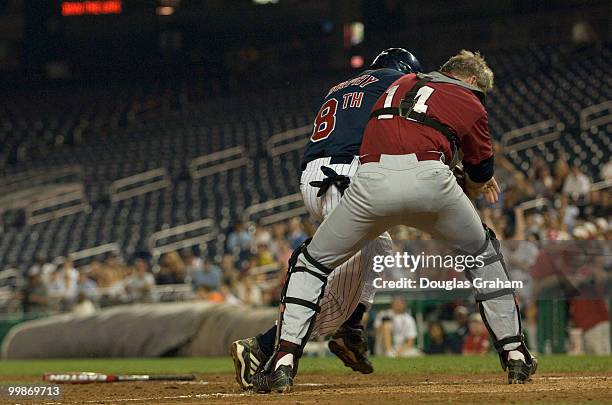 Christopher Murphy, D-Conn., hits catcher Gresham Barrett, R-SC., at home plate during the 47th Annual Roll Call Congressional Baseball Game at...