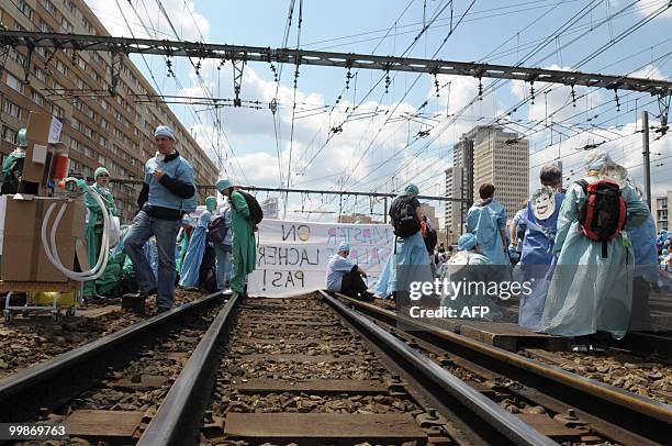 French anaesthetist nurses stand on tracks near the Montparnasse train station on May 18, 2010 in Paris, during a demonstration blocking the speed...