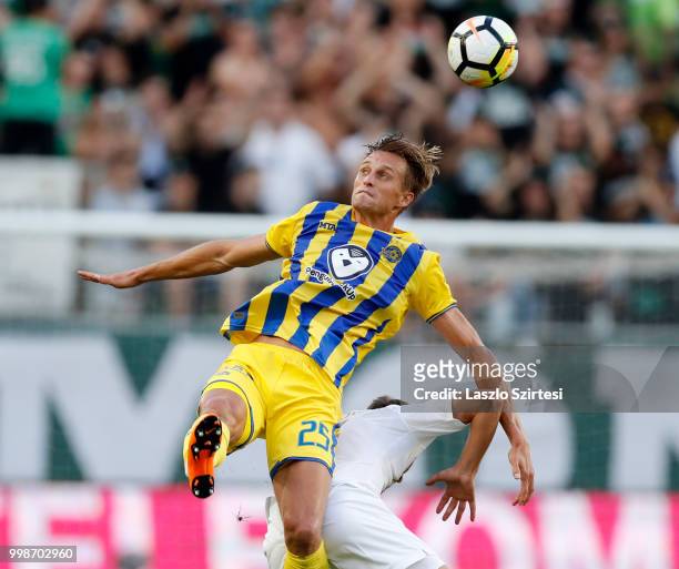 Aaron Schoenfeld of Maccabi Tel Aviv FC battles for the ball in the air with Stefan Spirovski of Ferencvarosi TC during the UEFA Europa League First...