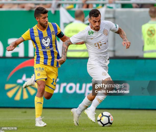 Davide Lanzafame of Ferencvarosi TC wins the ball from Dor Micha of Maccabi Tel Aviv FC during the UEFA Europa League First Qualifying Round 1st Leg...