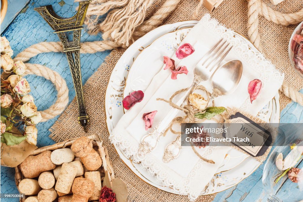 Tableware and silverware with dry flowers and different decorations