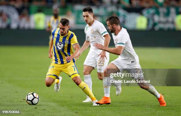 Omer Atzili of Maccabi Tel Aviv FC competes for the ball with Lukacs Bole of Ferencvarosi TC and Endre Botka of Ferencvarosi TC during the UEFA...