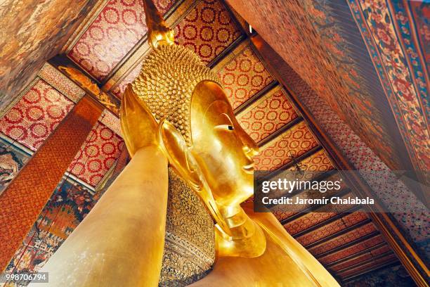 golden statue of the reclining buddha - reclining buddha statue stock pictures, royalty-free photos & images