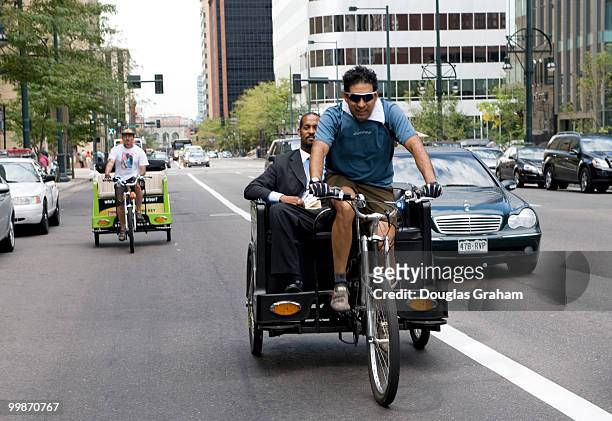 Rickshaw rides are a fun mode of transportation and all part of the "green movement" in Denver Colorado. Here Democratic National Convention goers...