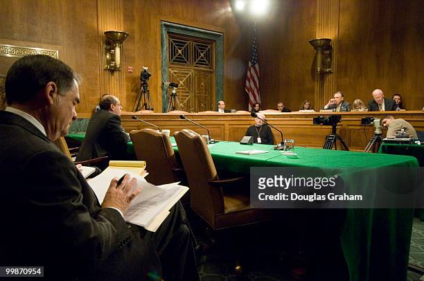 Former, Rep. Billy Tauzin, R-La., CEO of PhRMAArlen, goes over some paper work while Arlen Specter, R-PA., and Patrick Leahy,D-VT., question Jon...
