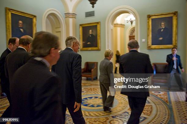 Senate Majority Leader Harry Reid, D-Nev., talks with Robert Menendez, D-N.J., as they walk through the Ohio Clock corridor September 17 on their way...