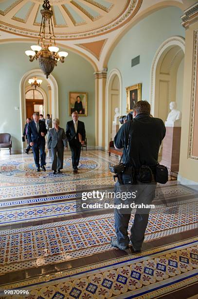 Staff photographer Bill Clark of Roll Call newspaper back-peddles as he photographs Senate Majority Leader Harry Reid, D-Nev., Sen. Patty Murray,...