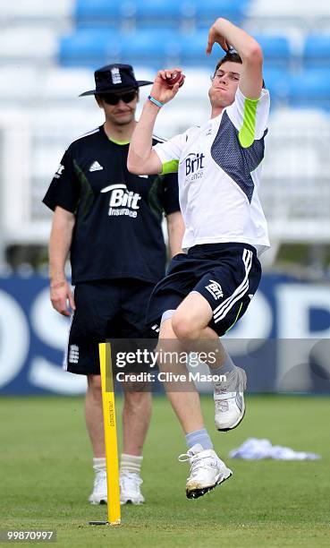 James Harris of England Lions bowls as bowling coach Kevin Shine looks on during a net session at The County Ground on May 18, 2010 in Derby, England.