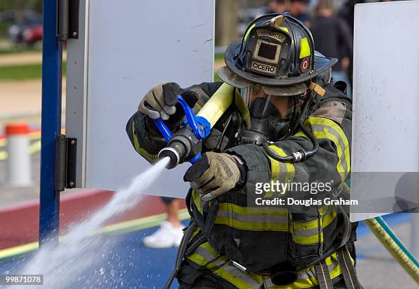 Firefighter hits a target with a water hose during the Firefighter Combat Challenge. The event attracts hundreds of U.S. And Canadian municipal fire...