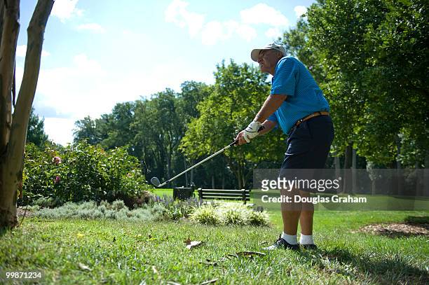 Joe Baca chips a ball onto the green during the First Tee Congressional Challenge golf tournament at Columbia Country Club in Chevy Chase, Maryland.
