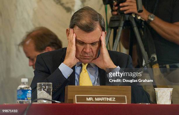 Mel Martinez, R-FL., reads documents during the Senate Banking, Housing and Urban Affairs Committee, full committee hearing on the Federal Reserve's...