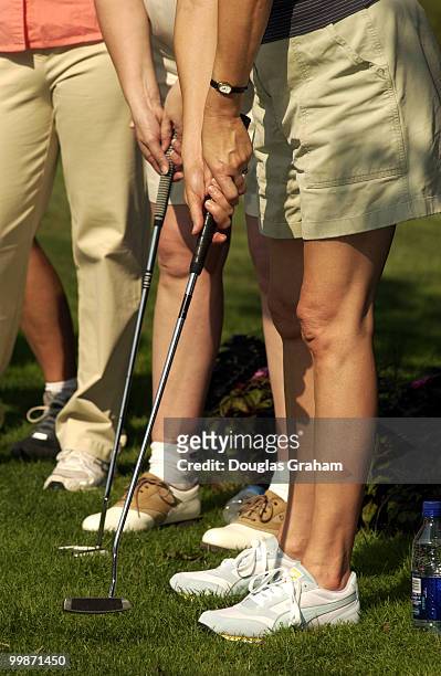 Julia Weller and a small group of female lobbyist works on their putting skills during "The Women's Networking Forum' Get Into the Swing" program to...