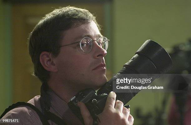 World renowned photojournalist Scott Ferrell shoots picture during a press conference on the attack of the U.S.S. Cole.