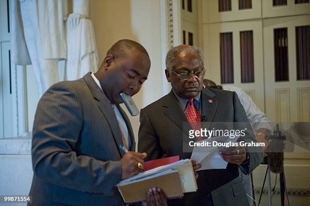 Jamie Harrison helps his boss James Clyburn, D-SC., with some paper work in the Will Rogers Corridor before going in front of the TV cameras to talk...