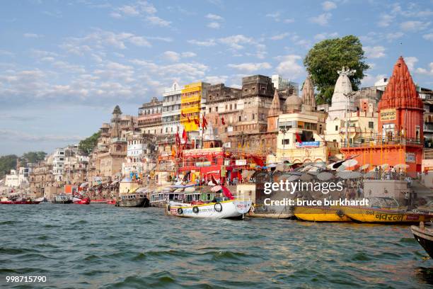 a view of the ghats of varanasi india from the ganges river. - bathing ghat fotografías e imágenes de stock