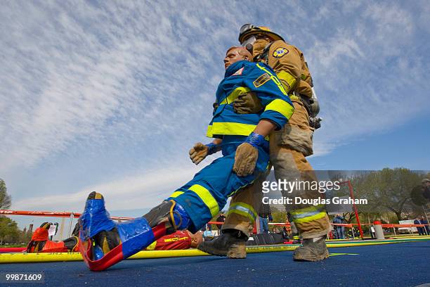 Here a firefighter picks up and drags "rescue Randy" during the Firefighter Combat Challenge. The event attracts hundreds of U.S. And Canadian...