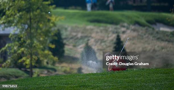 Buck McKeon, R-CA., digs one out of the sand trap at the First Tee Congressional Golf Tournament at TPC Potomac at Avenel Farm golf course, September...