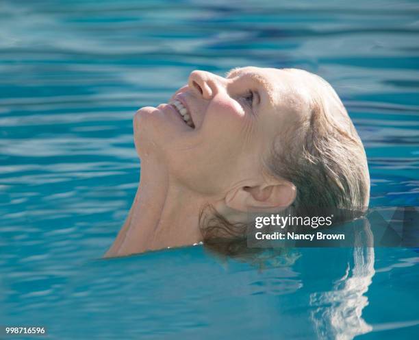 senior woman head shot in pool. - highland region stock pictures, royalty-free photos & images