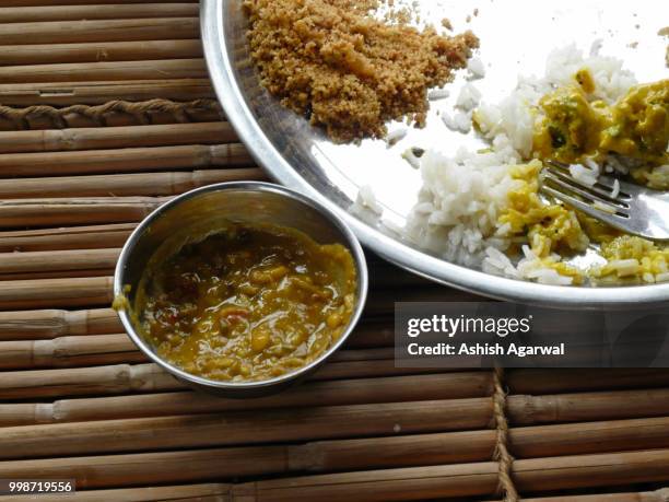 a typical plate of indian rajasthani food on a bamboo table - agarwal stock pictures, royalty-free photos & images