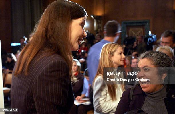 Geena Davis Oscar-winning actress talks with Leslie Annexsteinn before the start of the news conference to urge protection of athletic opportunities...