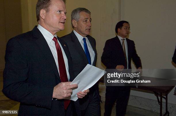 Jim Webb, D-Va. And Chuck Hagel, R-Neb., walk to a news conference to discuss the independent budget of leading veterans' organizations, including...