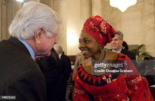 Chairman Edward Kennedy, D-Mass. And Princess Zulu, HIV/AIDS educator at World Vision greet each other before the start of the full committee hearing...