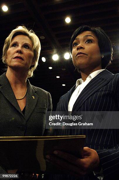 Donna de Varona and Dominique Dawes go over some paper work before they testify at a Senate Commerce Committee. The hearing comes at a time when the...