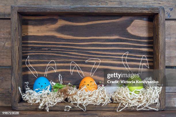 easter eggs with bunny ears in the nests in boxes - easter bunny ears ストックフォトと画像