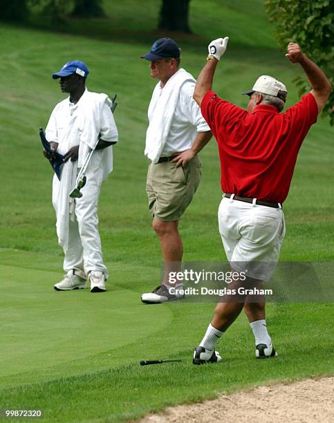 Joe Baca, D-CA., barley misses a long putt during the First Tee Congressional Challenge golf tournament at Columbia Country Club in Chevy Chase,...