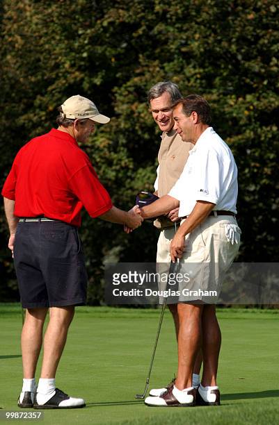 John Boehner, R-OH., is congradulated on a good putt by Chet Edwards, D-TX., as Ander Crenshaw, R-Fl., looks on during the First Tee Congressional...
